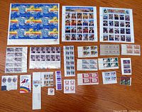 All stamp sheets, blocks and strips laid out on table