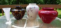 Four vases side by side on table