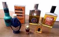 Group shot of seven vintage scent containers on table