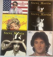 All six album covers laid out: four different Steve Martin titles with one duplicate, plus Robin Williams album