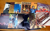 Group shot of all 11 album covers spread on table