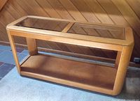Full front view of sofa table showing glass panels and wooden frame