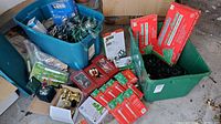 Overall view of totes containing boxed and loose Christmas lights, ornaments, electric candles