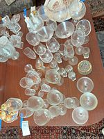 Overhead view showing full assortment of clear glass stemware and tumbler with gold rim