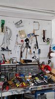 overview of pegboard wall with hanging tools and bench with drawer organizers