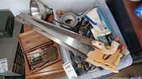 overview of tote with hand saws, wooden box, assorted tools