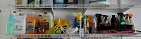 Wide shot of shelf with multiple auto care bottles, jugs, towels
