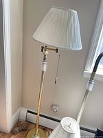 Full view of brass floor lamp with shade attached