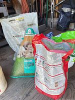 Multiple lawn-care product bags grouped in shed