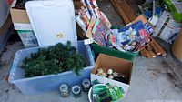Overall lot showing garland in tote, ornaments box, string lights, candles, timers