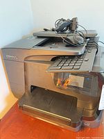 Printer with keyboard, mouse and headset stacked on top