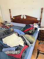 Overall view of king headboard with posts attached to bed, mattress and split base visible