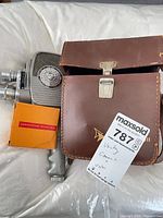 Camera, leather case, Kodachrome film box overview