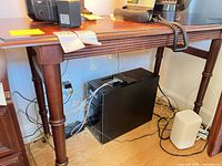 Full view of table used as desk, showing rectangular top, legs and general form