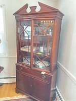 Full view of china cabinet showing pediment, glass doors, drawer and lower cabinet