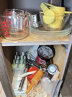 Overall view of mixed kitchenware on shelves