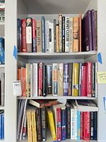 Two shelves filled with approximately 50 assorted books across multiple genres
