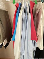 Rack showing mixed lot of long-sleeve shirts in various colours