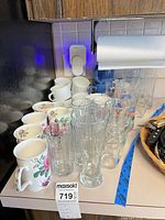 Group of mugs and glasses on countertop
