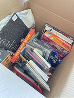 Box containing DVDs, Trolls puzzles, markers, books and other small items