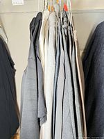 Group of shirts on hangers showing colour range and styles