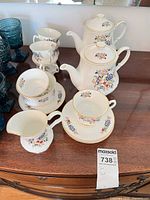 Full set on dresser showing teapot, creamer, cups and saucers