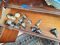 Drawer view showing group of tarnished silver-plated bells