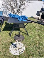 Table, umbrella and bases in yard