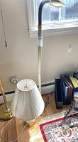 Group shot showing brass floor lamp, ivory gooseneck floor lamp and cut glass table lamp with shade