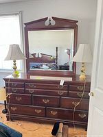 Full view of dresser with attached mirror and two lamps (lamps not included)