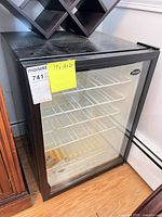 Front view of Vinotemp beverage cooler showing glass door and wire shelves