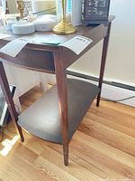 Front three-quarter view showing tabletop, drawer position, legs, lower shelf