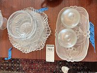 All items together: Waterford bowl stacked on two clear plates; frosted underplate with two covered dishes