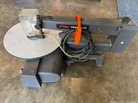 Left side view of Sears Craftsman scroll saw with table, guard and cord