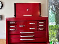 Front view of red Beach 12-drawer tool chest with lid open