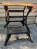 Full view of folded-out Black & Decker Workmate 200 workbench on gravel