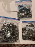 All three zipper bags containing fasteners on table