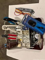 Open organizer toolbox showing contents and several hand tools