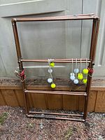 Full view of copper ladder-toss frame leaning against wall