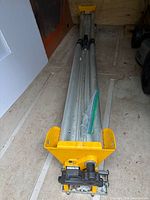 Stand folded with yellow end supports and rail visible