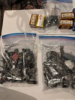 Overview of two bags of connectors, one bag of straps, and four boxed electrical parts