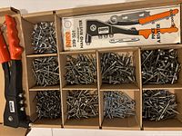 Papco hand riveter, instruction sheet and compartments filled with rivets
