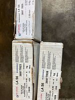 Three boxed spools showing product labels and part numbers 38977823 and 38977835