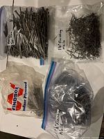 Four bags of loose nails and spikes