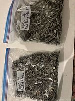 Two bags of roofing nails labeled 1" and 1-1/4"