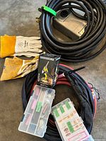 Coiled extension cable with outlet box, gloves, torch lead, consumable boxes