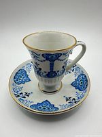 Teacup and saucer together showing pattern and gilt trim