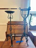 Front view of both metal candle holders showing overall design and size comparison