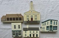 Front view of five Cat's Meow wooden buildings