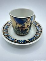 Cup placed on saucer showing Egyptian motif decoration